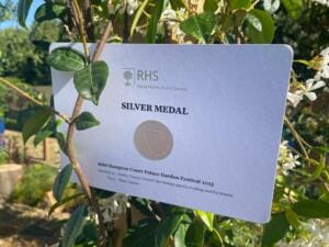 A close-up of the RHS Silver Medal certificate awarded to Surrey County Council for their show garden titled “Reclaiming Spaces, Creating Healthy Streets.”